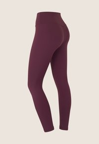 Leggings bordeaux a vita alta realizzati in un tessuto elasticizzato, con una superficie liscia e un design aderente dotato di una vita senza cuciture.