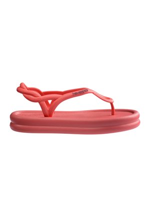Koralfarvet Havaianas gummi sandal med flettet ankelrem og polstret sål, designet til afslappet brug.