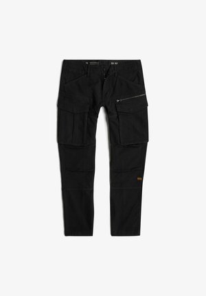 Pantalones cargo negros confeccionados con una tela duradera. Presentan múltiples bolsillos, un bolsillo lateral con cremallera y un pequeño logotipo naranja. Ajuste estándar.