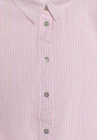 Camisa botão rosa claro com riscas brancas verticais. Apresenta um colarinho pontudo e seis botões arredondados com um ligeiro brilho.