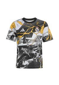 Kortærmet t-shirt med sort, hvid og gul tegneserieinspireret grafik og et Real Madrid-logo på brystet.