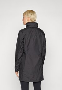 Black waterproof jacket with a high collar, long sleeves, and a straight cut; features smooth texture and minimal design.