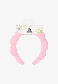 Pehmustettu ihonhoitopupakki pehmeässä vaaleanpunaisessa, jossa on aaltoileva muotoilu. Yksi koko sopii kaikille, ihanteellinen hiusten pitämiseen poissa ihonhoitorutiinien aikana.