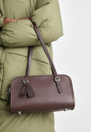 Brown leather handbag with a rectangular shape, a detachable strap, and silver hardware accent. Features two tags attached to the handle.