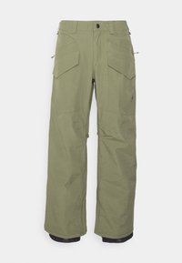 Pantalons cargo verts olive avec coupe droite, plusieurs grandes poches, chevilles zippées et tissu durable. Adaptés aux activités de plein air.