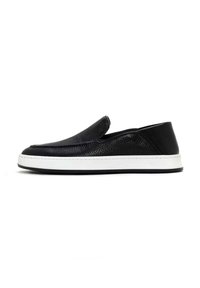 Black slip-on shoes made of textured leather with a white rubber sole, featuring a streamlined design and subtle stitching detail.