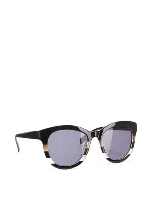 Cat-eye style sunglasses with black, white, and gold striped frames and dark tinted lenses on a white background.