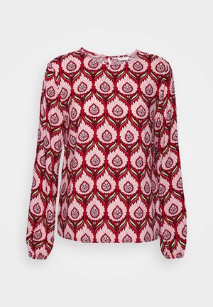 Long-sleeve blouse with red, pink, and black floral pattern and round neckline, displayed against a white background.