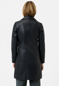 Black leather coat with long sleeves and a notch collar. Smooth texture, tailored fit, mid-thigh length, and minimalistic design.