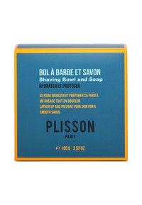 Scheerkom en zeepdoos met een blauwe achtergrond, oranje accenten en vetgedrukte zwarte tekst. Bevat instructies in meerdere talen en branding.