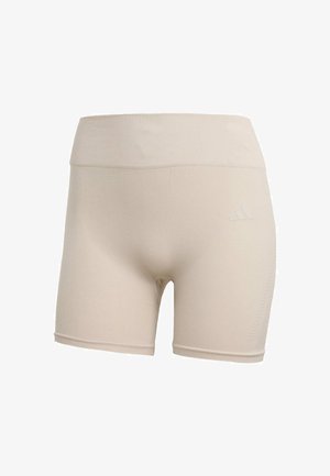 Bermudas deportivas beige con una cinturilla ancha, textura acanalada y un logo sutil en el lateral. La tela parece elástica y suave.