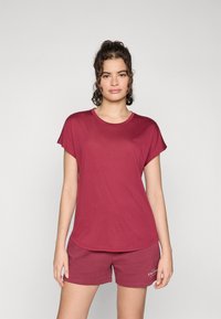 Maroon cotton t-shirt with short sleeves and a round neckline, paired with matching maroon shorts featuring a small logo on the hem.