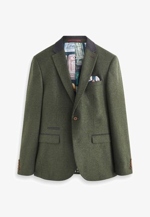 Blazer en laine verte avec un col cranté, fermeture à boutons marron, et deux poches avant. L'intérieur est doté d'une doublure à motifs et d'un pochette.