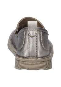 Metallic silver slip-on shoe with a textured surface, smooth edges, and a flat, ridged sole. Features a decorative back tab and stitched accents.