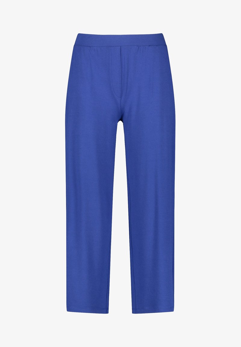 Niebieskie elastyczne spodnie o prostych nogawkach, z gładką fakturą i elastycznym paskiem w talii. Bez widocznych kieszeni i ozdób.
