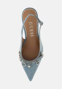 Denim slingback shoe in light blue with pointed toe. Features silver chain accents and decorative charms. Soft interior with logo detail.