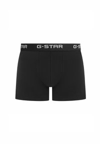 Black boxer briefs features a smooth texture with a snug fit. Waistband displays "G-STAR" in contrasting white font.