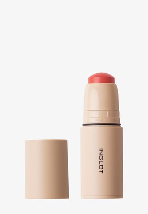 Stick de maquillage Inglot beige avec produit crème rose corail exposé, bouchon retiré et placé à côté sur fond blanc.