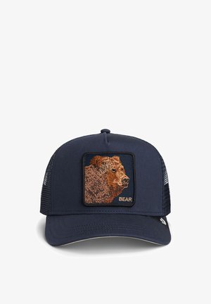 Navy blue trucker cap with mesh back, featuring an embroidered brown bear head patch and the word "BEAR" on the front.