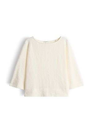 Pull en maille côtelée couleur crème avec manches larges et encolure ronde, présenté à plat sur un fond blanc.