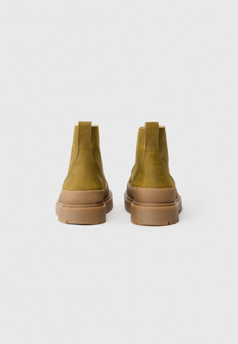 Olive green leather ankle boots with a tan rubber sole and rounded toe. Features a pull tab at the back and visible stitching accents.