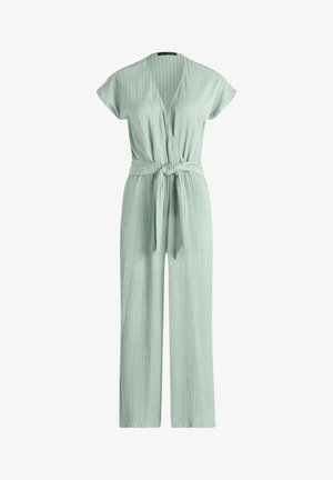 Világoszöld bordázott kötött overál rövid ujjakkal, V-nyakú átfedős elülső résszel, derekán megkötős, és széles szárú.