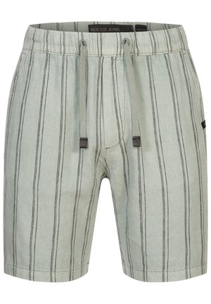 Pantaloni corti verde chiaro con strisce nere verticali, vita elastica, chiusura con cordino e due tasche laterali. Realizzati in un tessuto morbido e testurizzato.