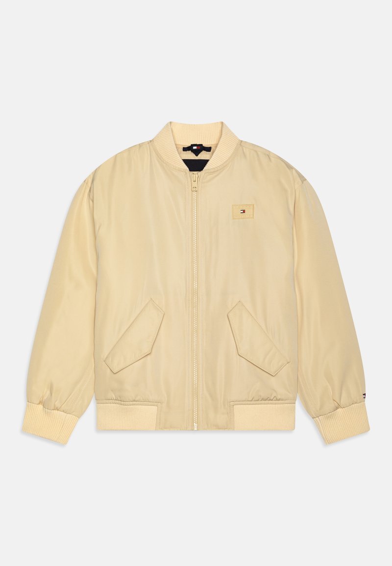 Helebeež bomber-jakk, millel on ribistatud krae ja varrukad, kaks eesmist taskut, tõmblukuga sulgemine ja väike logopatch rinna peal.