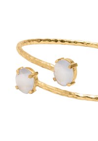 Złota bransoletka z teksturowanym, młotkowanym wzorem, zdobiona dwoma okrągłymi, fasetowanymi jasnoniebieskimi kamieniami osadzonymi w złotych pazurkach.