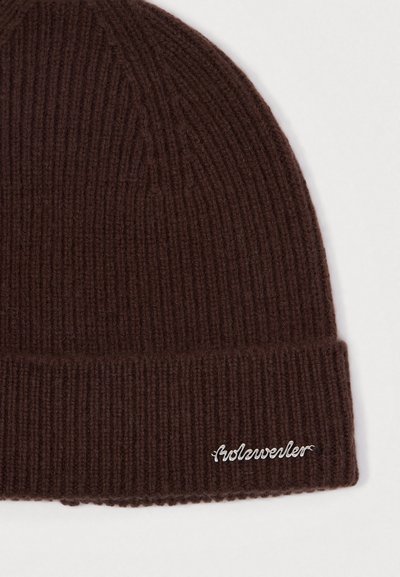 Brown knit beanie with ribbed texture and a folded cuff, featuring white embroidered text on the front.