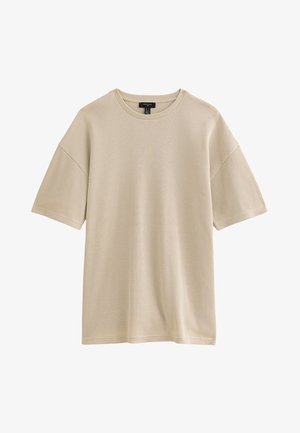 T-shirt à manches courtes en tricot côtelé beige avec un col rond et une coupe décontractée, présenté sur un fond blanc.