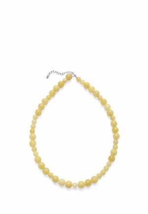 Żółty naszyjnik z okrągłych koralików o różnych rozmiarach, z regulowanym srebrnym zapięciem na łańcuszku na białym tle.