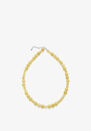 Kollane ümmargune helmestega kaelakee, mille helmeste suurus suureneb järk-järgult ja millel on valgel taustal hõbedane reguleeritav kett-kinnitus.