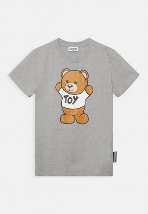 Light gray short-sleeve t-shirt with a teddy bear wearing a white shirt that reads "TOY," Moschino brand label visible on collar and side.
