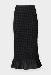 Mustru mustreeritud must pencil seelik, millel on volangääre ja sile vöökoht, valmistatud kergest kangast.