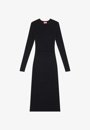 Mustassa ribbikudotussa mekossa on pitkät hihat, pyöreä kaula-aukko ja leikattu yksityiskohta vyötäröllä. Mekossa on myös näkyvä punainen "DIESEL" -logolappu.