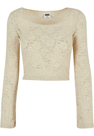 Haut court à manches longues en dentelle crème avec un décolleté arrondi. Motif floral distinct sur tout le tissu, avec une texture légère et délicate.