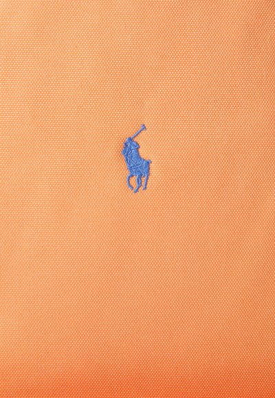 Tessuto arancione testurizzato con un piccolo logo ricamato di un giocatore di polo blu centrato sul materiale.