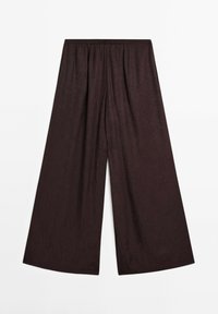 Pantalon noir à jambes larges avec taille élastique et motif subtil en tissu texturé, posé à plat sur un fond blanc.