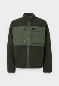 Fleece jacket in dark green with a zip-up front. Features a patch pocket and textured fabric. High collar with minimal hardware details.