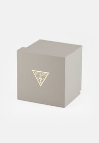 Gray textured box with a triangular gold logo on the front. The design features a clean, modern shape and folded corners.
