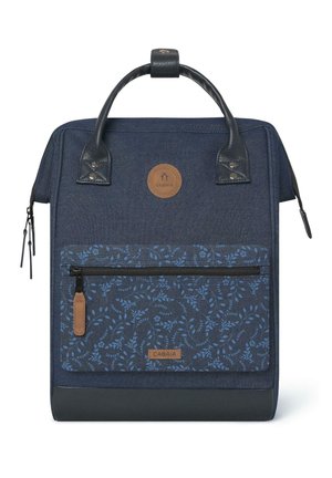 Navy blue backpack with a floral-patterned front pocket, leather accents, top handle, and a zippered compartment. Durable fabric construction.