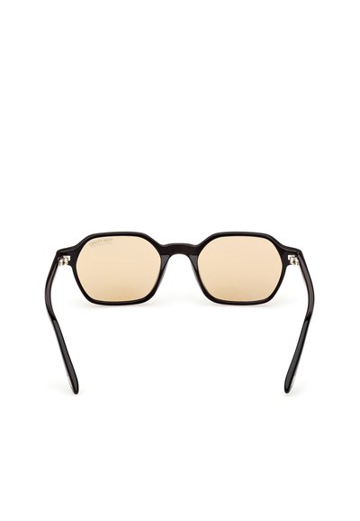 Oktagoniset aurinkolasit, joissa on kiiltävä musta muovikehys. Vaaleat sävytetyt linssit. Ominaisuuksiin kuuluu ohuet, suorat sälut, joissa on tyylikäs muotoilu.