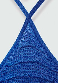 Blue knitted bikini top with a triangular shape, featuring cross-back straps and a textured finish. The material appears shiny and breathable.