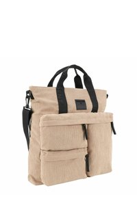 Borsa a mano in corduroy beige con dettagli neri, dotata di doppio manico superiore, tracolla regolabile e due tasche frontali con zip.