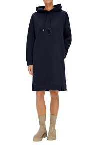 Marinblå huvtröjklänning i mjukt material, med långa ärmar, sidofickor och justerbara snoddar i huvan.