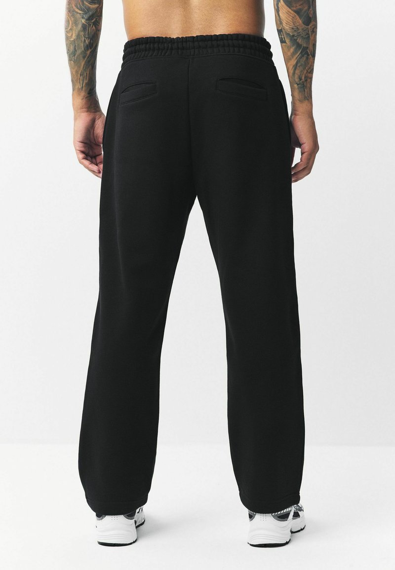 Next OPEN RICH Pantalones deportivos black/negro