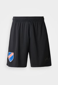 Fekete sport rövidnadrág, elasztikus derékpánttal, kék és piros pajzs logóval, rajta a "COLO COLO" felirattal és egy diszkrét fekete Adidas logóval.
