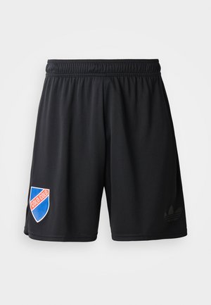 Shorts de sport noirs avec une taille élastique, comportent un logo écusson bleu et rouge avec "COLO COLO" et un subtil logo Adidas noir.