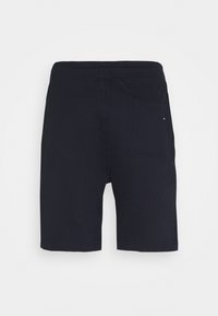 Short noir mi-long avec une ceinture élastique et une seule poche arrière droite avec un petit logo.